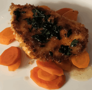 Pan-fried chicken on carrots